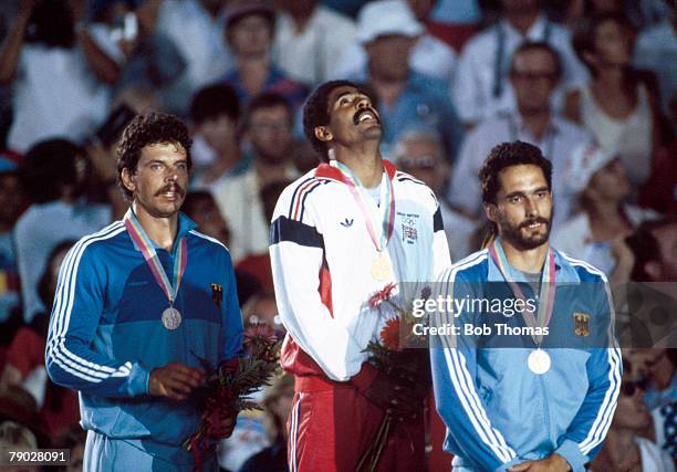 Medal winners of the Men's decathlon event stand together on the podium with, from left to right: silver medal winner Jurgen Hingsen of West Germany,...