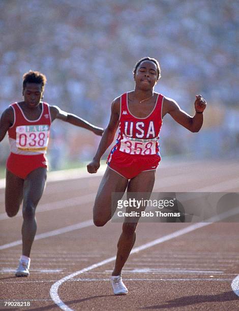 American track athlete Evelyn Ashford crosses the finish line in first place in 10.97 seconds to win the gold medal in the final of the Women's 100...