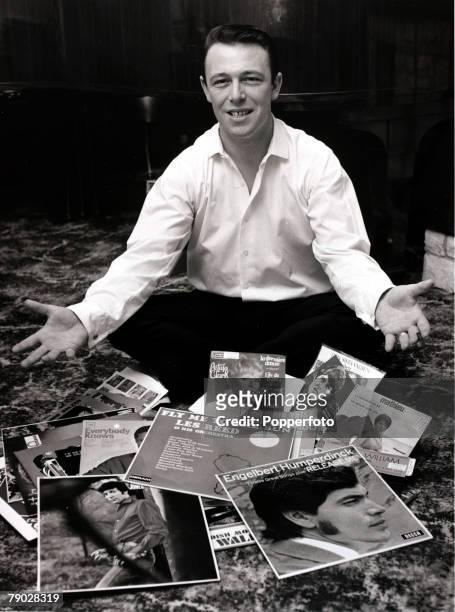 Entertainment/Music, 7th December 1967, Pop music composer Les Reed sits amongst some of the records he composed