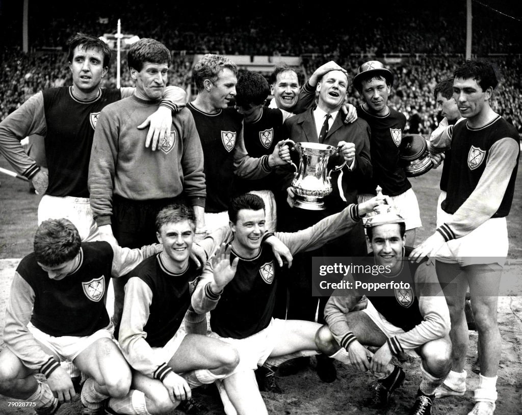 2nd May 1964. FA Cup Final. Wembley. West Ham Utd 3 v Preston North End 2. Victorious West Ham team including Johnny Byrne (3rd left, front row) and manager Ron Greenwood (holding cup, back row). Captain Bobby Moore is 3rd from the left, back row.