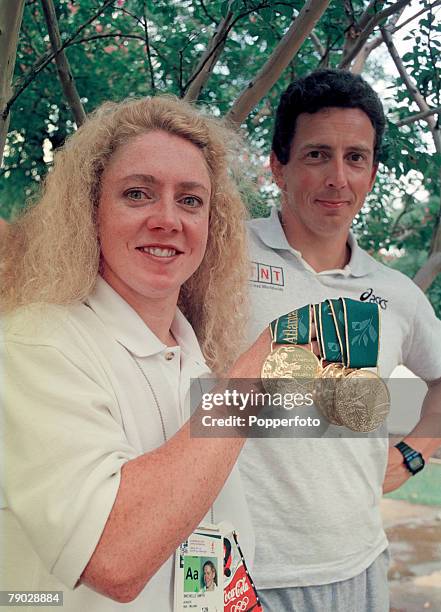 Irish swimer Michelle Smith poses alongside her husband Erik de Bruik with the three gold medals she won in the 400 metres freestyle, 200 metres...
