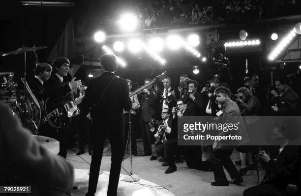 Members of British Rock pop group the Beatles face the cameras at a photo-call to promote their appearance on 'The Ed Sullivan Show' at CBS's Studio...