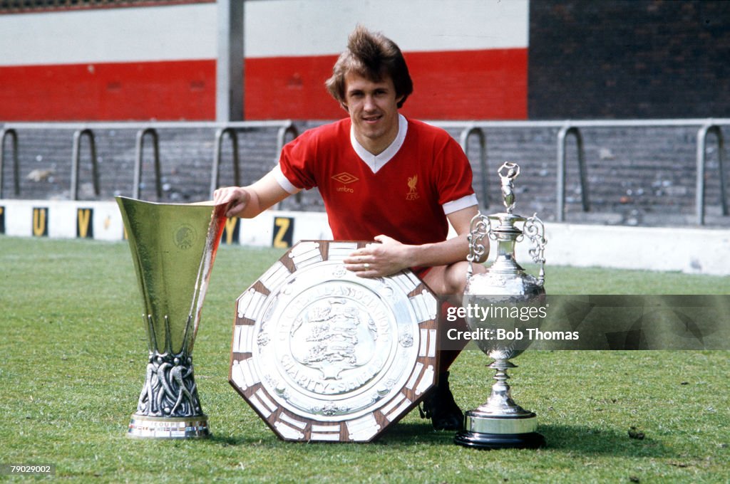 Sport. Football. 1976. Liverpool's Phil Neal is pictured with the L-R: UEFA Cup, Charity Shield, and League Championship trophies.