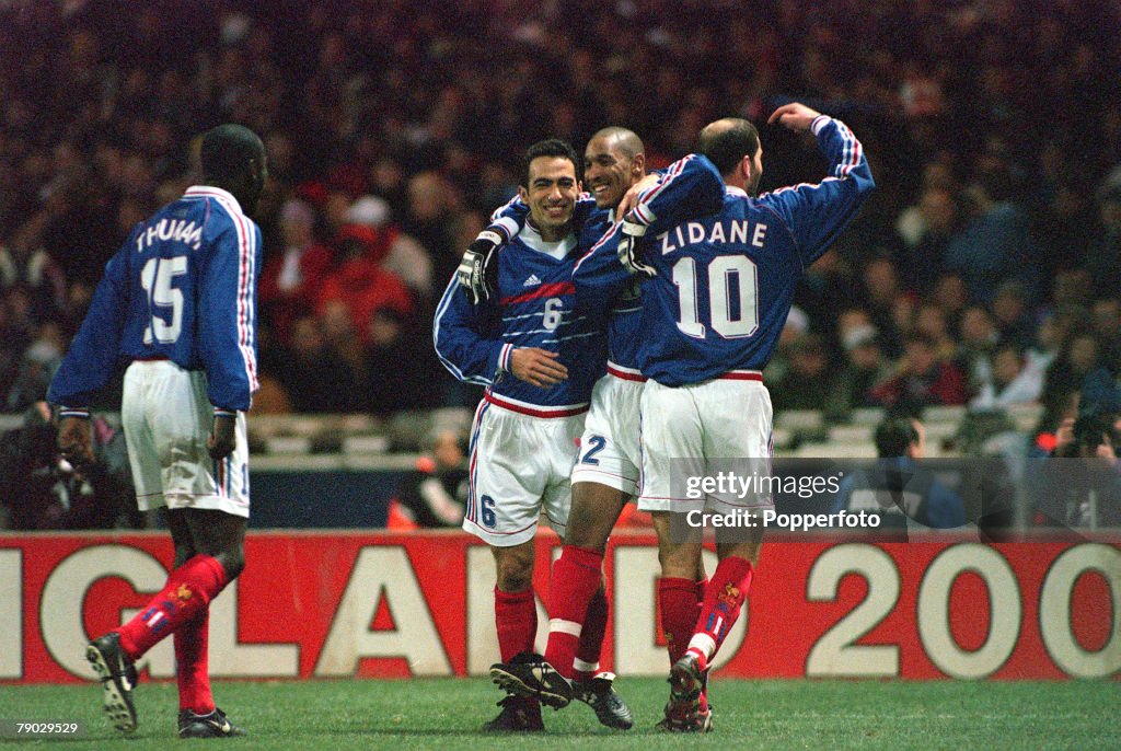 Football. 1999 International Friendly. Wembley. 10th February, 1999. England 0 v France 2. France's Nicolas Anelka is congratulated by teammates Youri Djorkaeff (6) and Zinedine Zidane (10) after scoring the first of his two goals.
