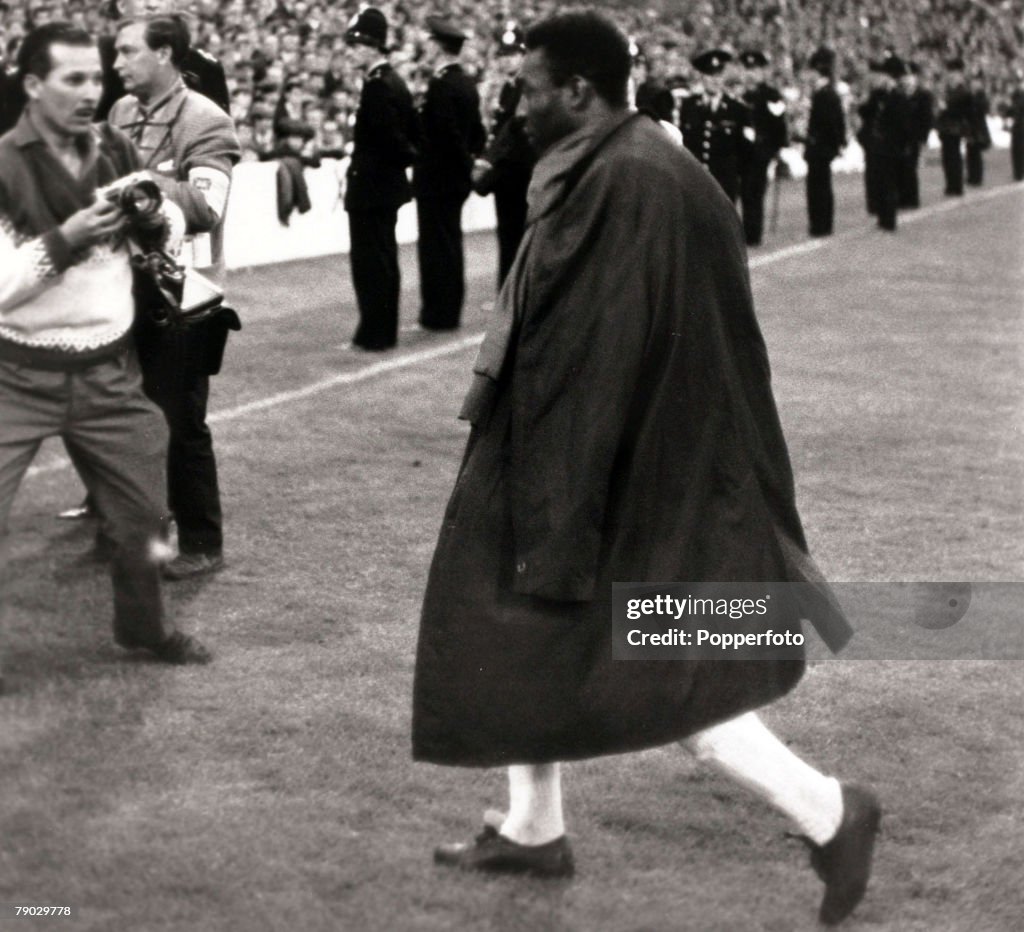 Sport. Football. 1966 World Cup Finals. Goodison Park, Liverpool, England. 19th July 1966. Group 3. Brazil 1 v Portugal 3. Brazil star Pele leaves the field with a raincoat slung over his shoulders, after being injured and forced from the game by some cru