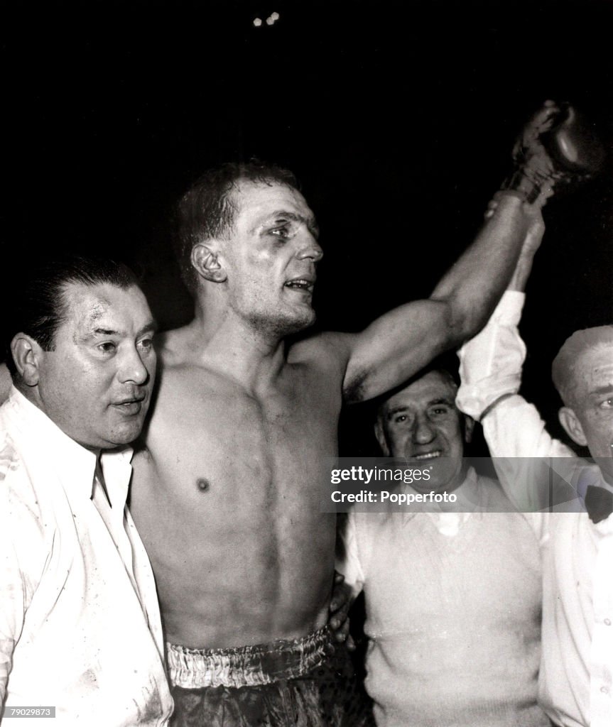 Sport/Boxing. Earls Court, London, England. 12th January 1959. British Heavyweight Championship. The new British Heavyweight Champion Henry Cooper has his arm raised after beating Brian London on points over 15 rounds. With him is trainer/cuts man Danny H
