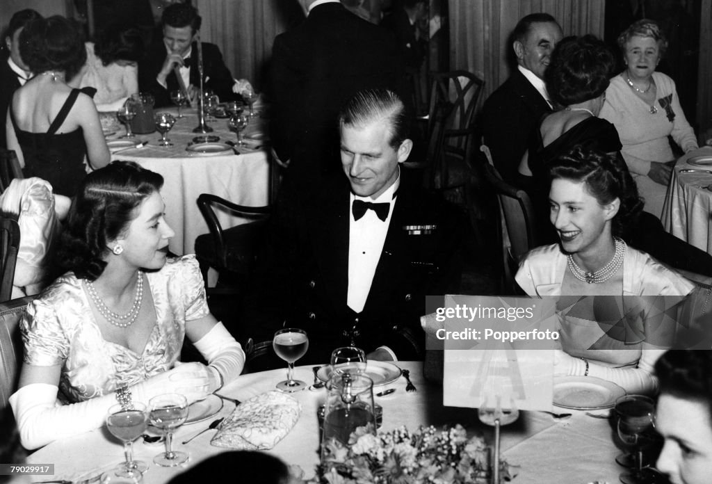 London, England. 5th May 1948. Princess Elizabeth, the Duke of Edinburgh and Princess Margaret sit for supper when they attended the Charity Ball held in aid of King George V Sailor fund at the Dorchester Hotel.