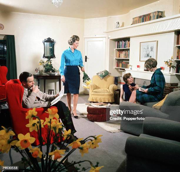 Picture of the British actor Ian Carmichael sitting whilst relaxing with his family at home