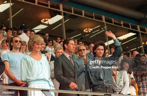 London, England, 13th July 1985, The Prince and Princess of Wales are pictured with a waving Bob Geldof at the Live Aid concert at Wembley Stadium,...