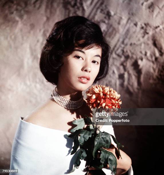 Circa 1960+s, A picture of the Eurasian actress France Nuyen doing an impression of the Italian beauty Gina Lollobrigida