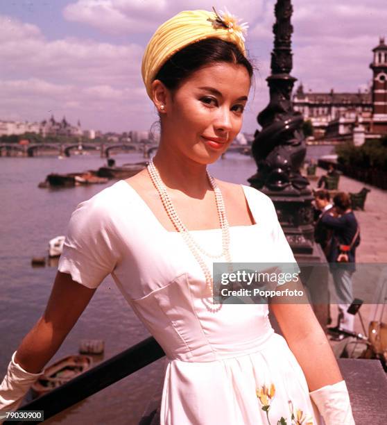 Circa 1960+s, A portrait of the Eurasian actress France Nuyen standing on the embankment overlooking the river Thames