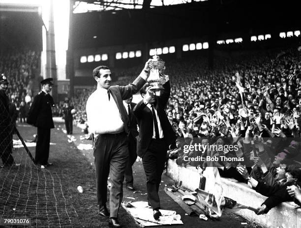 Sport, Football, Anfield, England Liverpool FC's Gerry Byrne and Gordon Milne show the FA Cup trophy to the "Kop", Byrne broke his collar-bone during...