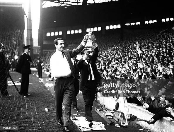 Sport. Football. Anfield, England. 1965. Liverpool FC's Gerry Byrne (left) and Gordon Milne show the FA Cup trophy to the "Kop". Byrne broke his collar-bone during the Final at Wembley during the 2-1 victory over Leeds United. Sport. Football. Anfield, England. 1965. Liverpool FC's Gerry Byrne (left) and Gordon Milne show the FA Cup trophy to the "Kop". Byrne broke his collar-bone during the Final at Wembley during the 2-1 victory over Leeds United.