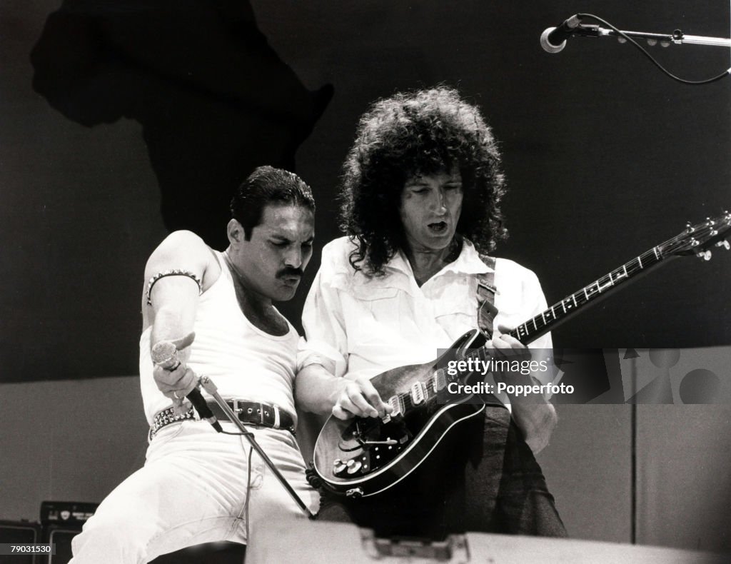 Entertainment/Music. Live Aid Concert. Wembley, London, England. 13th July 1985. British singer Freddie Mercury with guitarist Brian May as "Queen" perform at the charity concert.