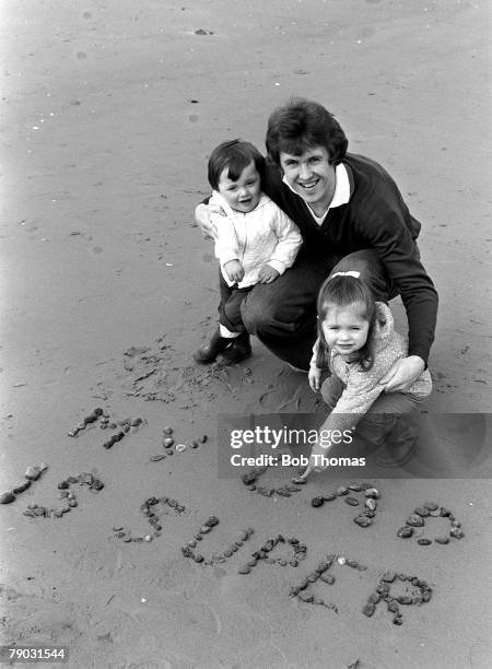 Football Liverpool and England defender Phil Neal writing in the sand with his two children Natasha and Ashley on the beach at Formby