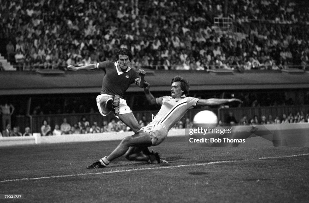 Football. August 1976. Coventry City v Manchester United. Manchester United+s Steve Coppell crosses the ball past Coventry+s Jimmy Holmes.