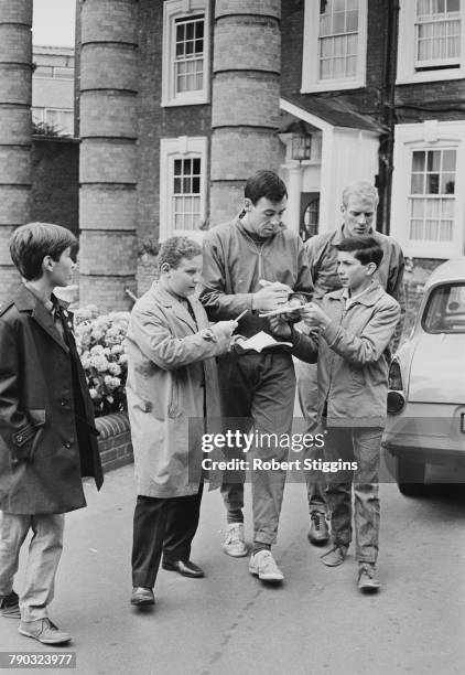 England goalkeeper Gordon Banks signs autographs for fans outside the Hendon Hall Hotel, Hendon, London, during the 1966 World Cup tournament, 27th...