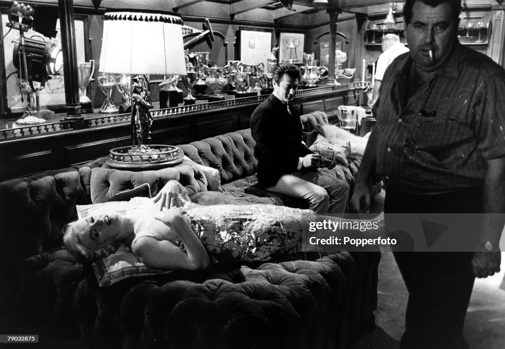 Entertainment. Films. USA. 1959. Behind the scenes during the making of the comedy film -Some Like it Hot+. Legendary actress Marilyn Monroe lies back on the chesterfield style seating of the luxurious train carriage and covers up her revealing dress duri