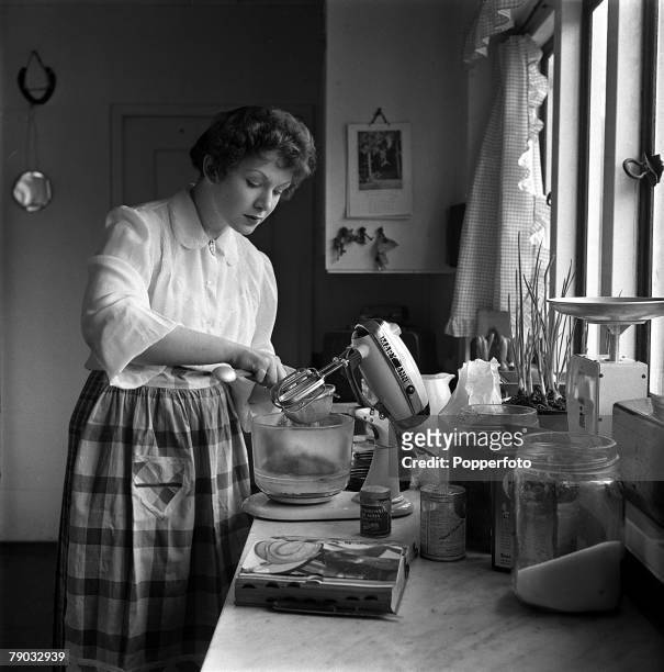 England British actress Jean Kent is pictured cooking at her home