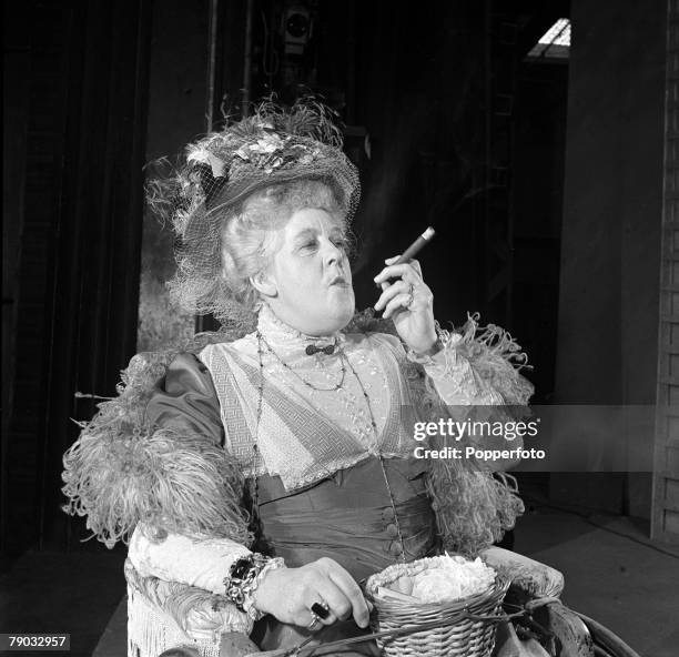 England Legendary British actress Margaret Rutherford is pictured smoking a cigar on the set of the play "Ring Round the Moon" where she plays the...