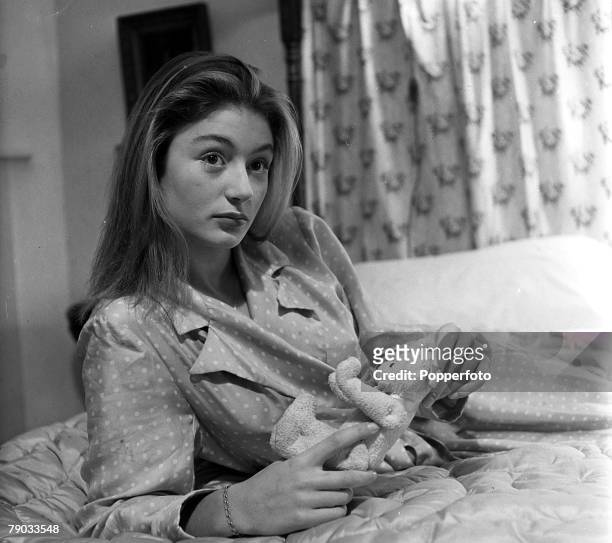Denham Village, England 17 year old French actress Anouk Aimee who is in England to act in the film "Golden Salamander" is pictured holding a teddy...