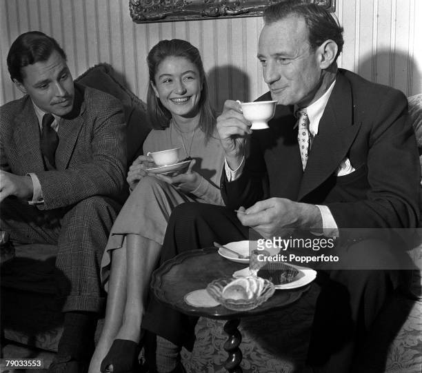 Denham Village, England 17 year old French actress Anouk Aimee who is in England to act in the film "Golden Salamander" is pictured with actors Ivan...