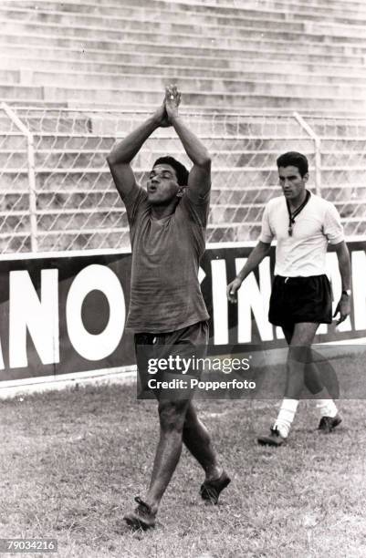 Sport, Football, January 1966, Brazil star Garrincha appearings to offering up a prayer as he is pictured at a training session, He played 60 times...