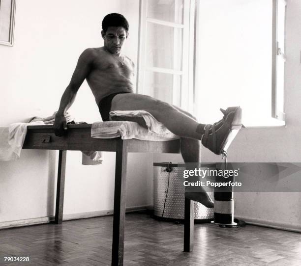 Sport, Football, April 1966, Brazil star Garrincha in the treatment room doing weight exercises on his right leg after an injury, He played 60 times...