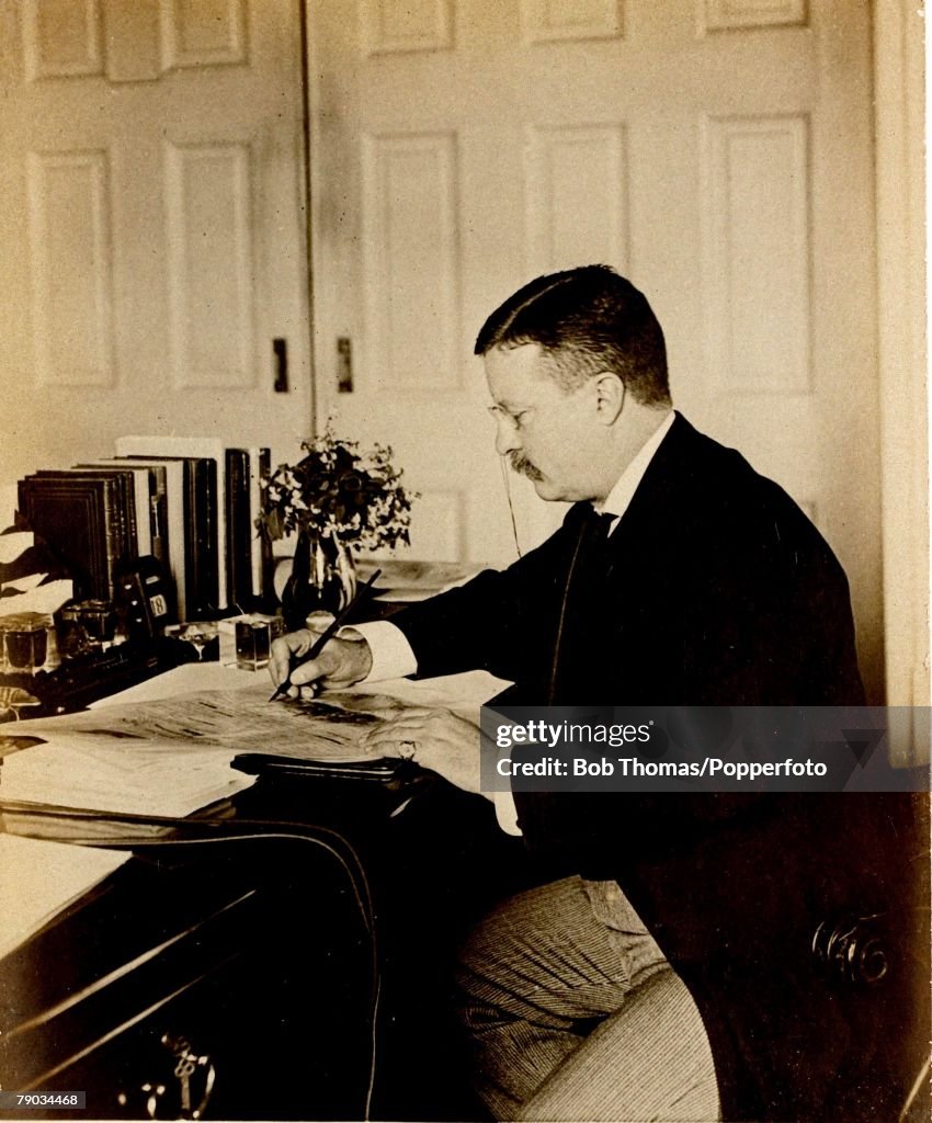 Politics. Theodore Roosevelt, (1858-1919). U.S.President 1901-1909. President Roosevelt pictured at his desk in the White House, Washington D.C.