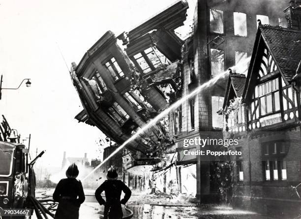 Popperfoto via Getty Images, The Book, Volume 1, Page 71, Picture 7 A picture of firemen fighting a fire in London as the entire front wall of a...