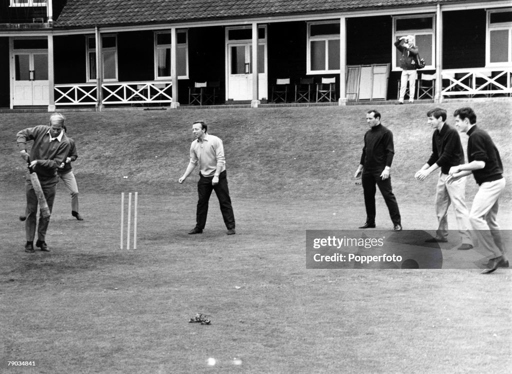 Sport. Football. Roehampton, England. 7th July 1966. A friendly cricket match between the England World Cup football squad. Bobby Charlton is pictured batting as L-R: Nobby Stiles, Ron Springett, Martin Peters and Peter Bonetti do the fielding during a br