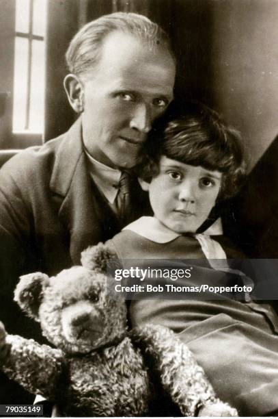 English author A.A. Milne, , with his son Christopher Robin and the teddy bear, Pooh Bear at Cotchford Farm, their home in east Sussex, 1926.