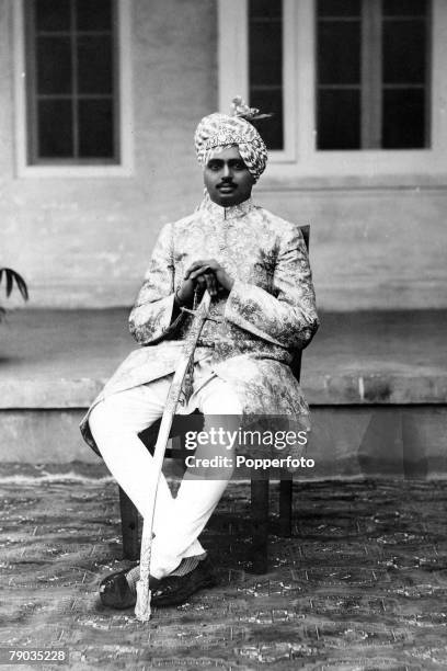 Popperfoto via Getty Images, The Book Volume 1, Page 64, Picture 10, A picture of the Rajah of Jasdan seated holding a long sword, within a native...