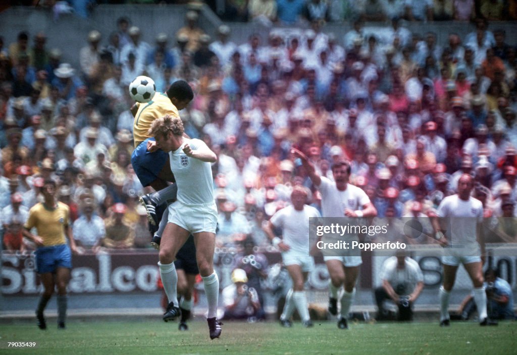 Football. 1970 World Cup Finals. Guadalajara, Mexico, 7th June, 1970. England 0 v Brazil 1. England captain Bobby Moore challenges Brazil's Jairzinho for the ball in the air.