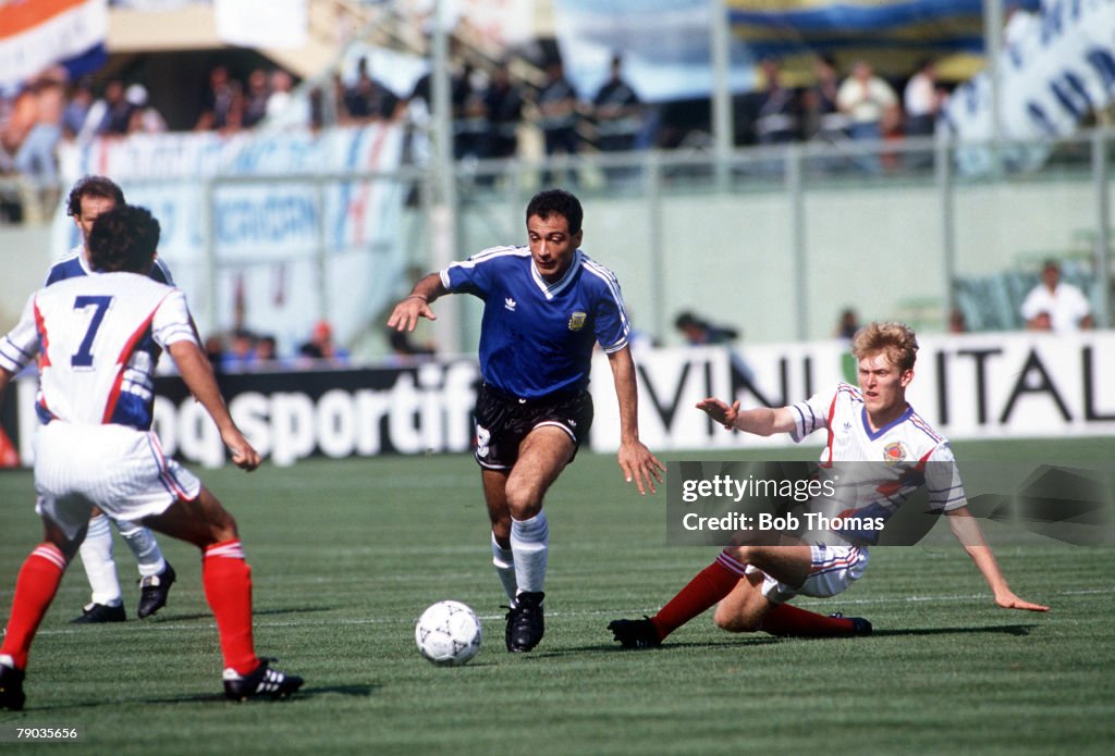 1990 World Cup Quarter Final. Florence, Italy. 30th June, 1990. Argentina 0 v Yugoslavia 0. (Argentina win 3-2 on penalties). Argentina's Jose Serrizuela is challenged for the ball by Yugoslav defenders.