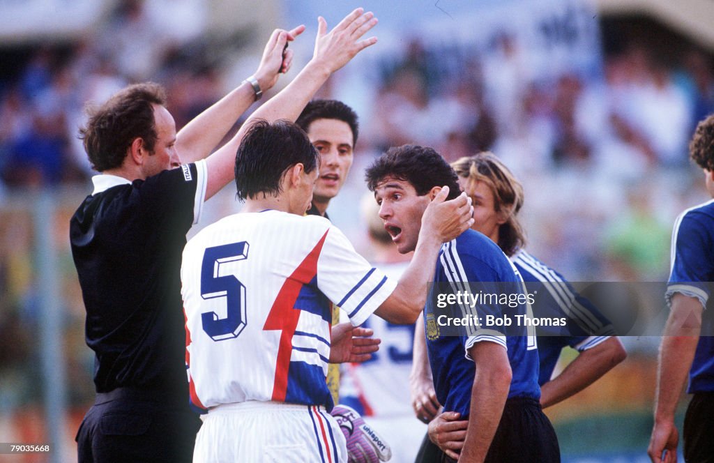 1990 World Cup Quarter Final. Florence, Italy. 30th June, 1990. Argentina 0 v Yugoslavia 0. (Argentina win 3-2 on penalties). Argentina's Jorge Burruchaga argues with Yugoslavia's Faruk Hadzibegic as the referee watches.