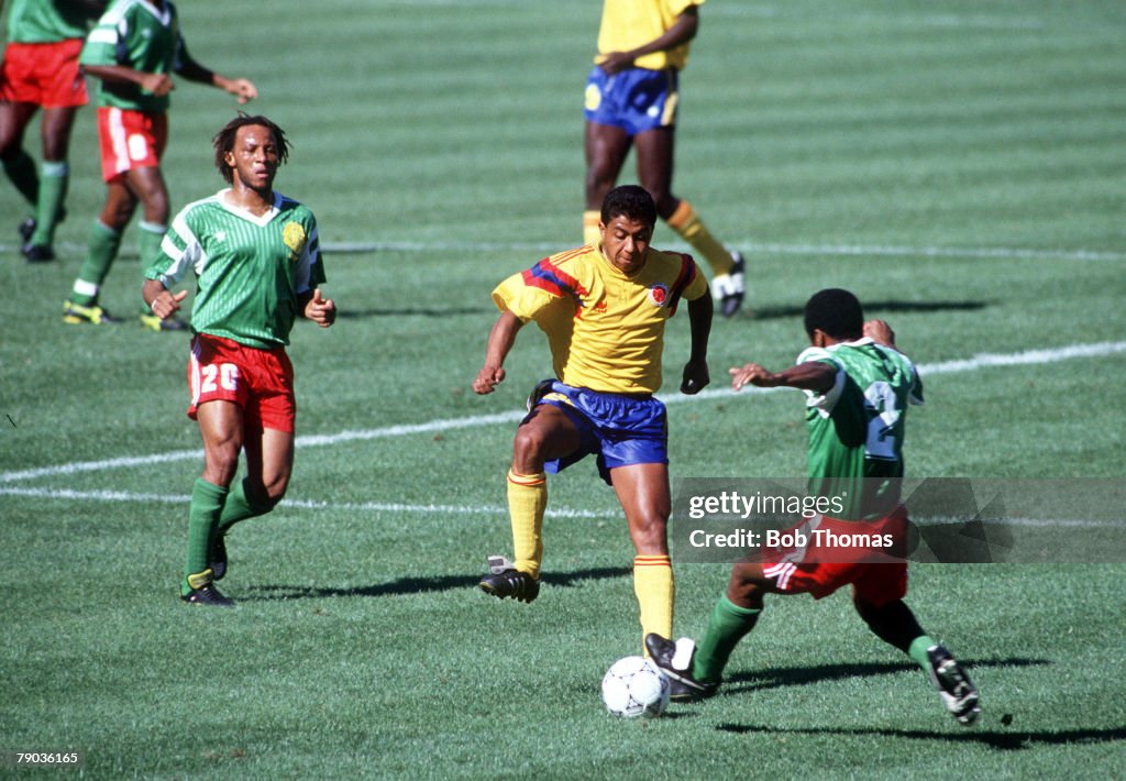 1990 World Cup Finals. Second Phase. Naples, Italy. 23rd June, 1990. Cameroon 2 v Colombia 1. Colombia's Luis Fajardo is challenged for the ball by Cameroon's Kana Biyick as Cyrille Makanaky (left) looks on.