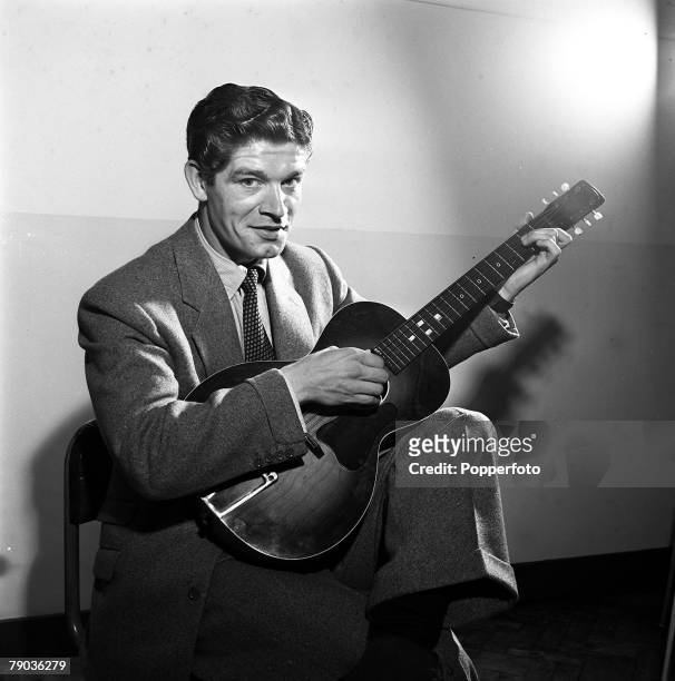 Cinema, England Irish born film actor Stephen Boyd is pictured playing a guitar