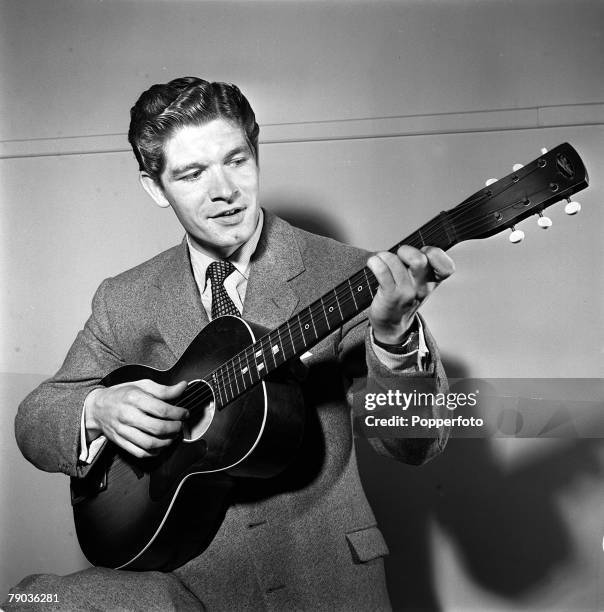 Cinema, England Irish born film actor Stephen Boyd is pictured playing a guitar