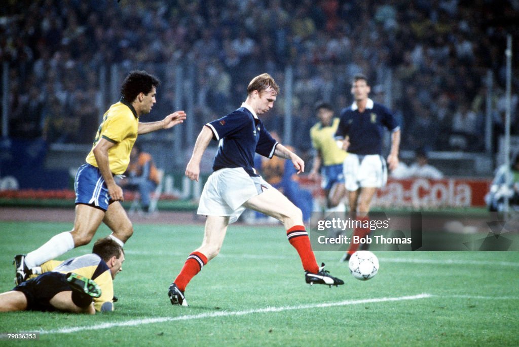 1990 World Cup Finals. Turin, Italy. 20th June, 1990. Brazil 1 v Scotland 0. Scotland's Alex McLeish clears the ball from danger watched by Brazilian attacker Careca.