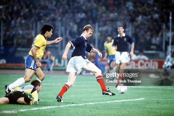 World Cup Finals, Turin, Italy, 20th June Brazil 1 v Scotland 0, Scotland's Alex McLeish clears the ball from danger watched by Brazilian attacker...