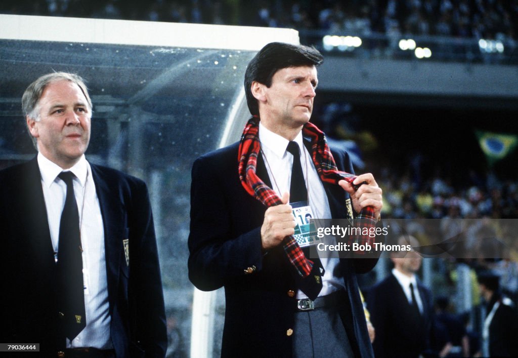 1990 World Cup Finals. Turin, Italy. 20th June, 1990. Brazil 1 v Scotland 0. Scotland's manager Andy Roxborough, waering a tartan scarf, watches the game with assistant Craig Brown.