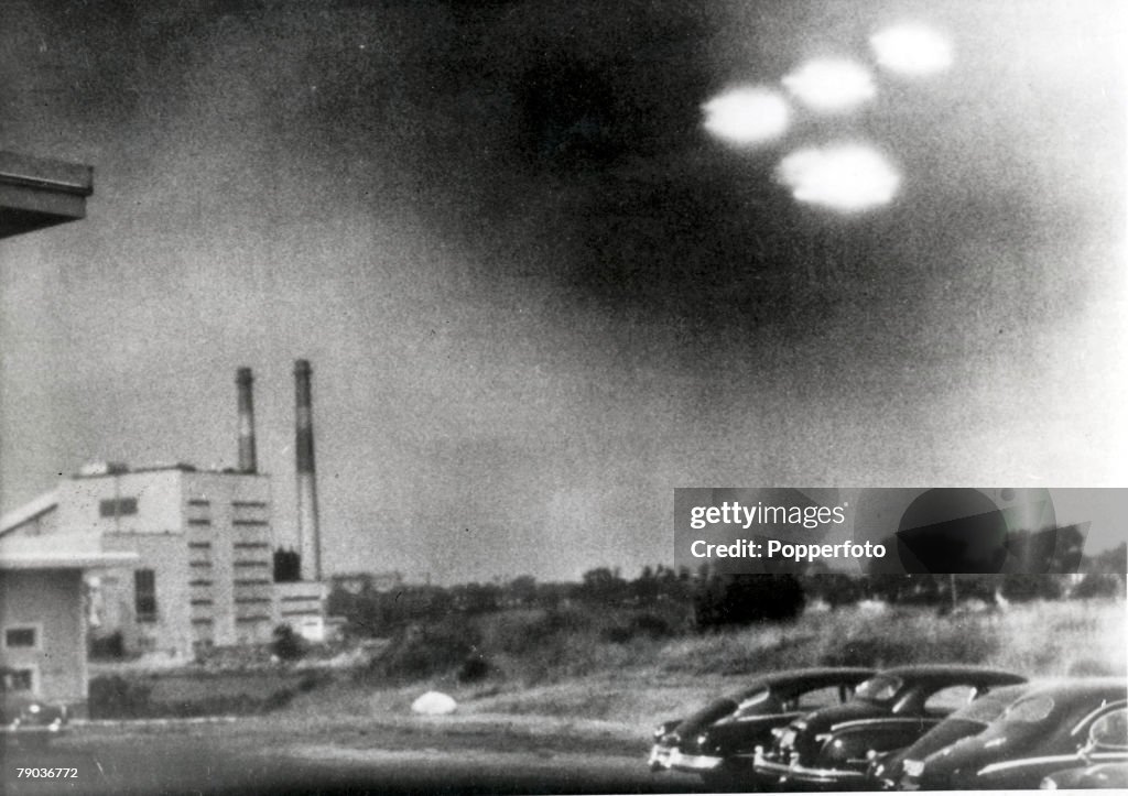 Salem, Massachusetts, USA. 3rd August, 1952. This picture, taken through the window of a laboratory by a 21 year old U.S. coastguard, shows four unidentified flying objects as bright lights in the sky. Many American's believe them to be flying saucers.