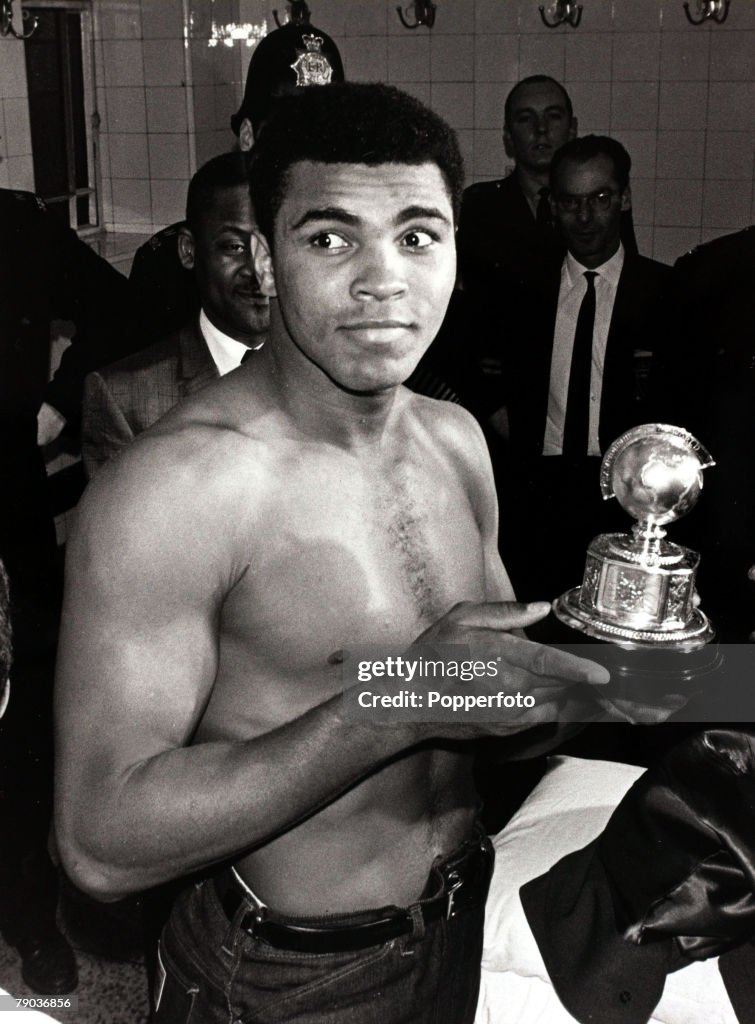 Sport. Boxing. England. 21st May 1966. World Heavyweight Championship at Highbury, London. Muhammad Ali beat Henry Cooper. World Champion USA's Muhammad Ali with an award presented to him after beating Great Britain's Henry Cooper who was stopped with a c