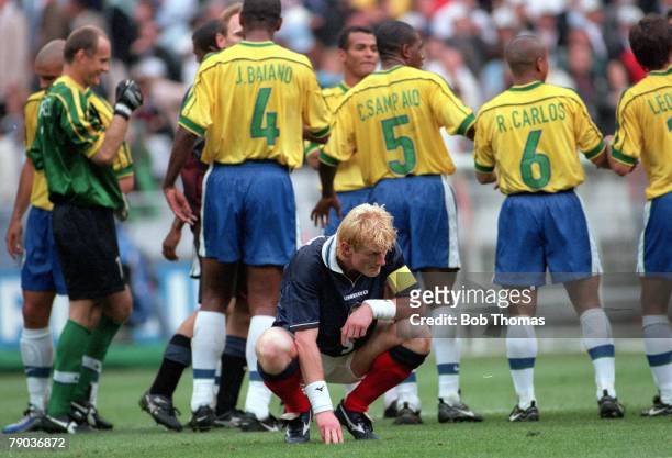 World Cup Finals, St Denis, Paris, 10th June Brazil 2 v Scotland 1, Scotland's captain Colin Hendry crouches down dejectedly at the end of the game...
