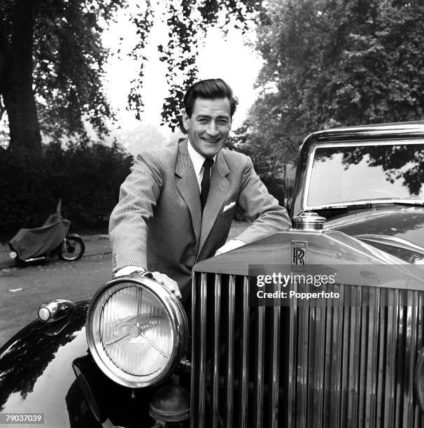 Cinema, England British actor Guy Rolfe is pictured next to his Rolls Royce car