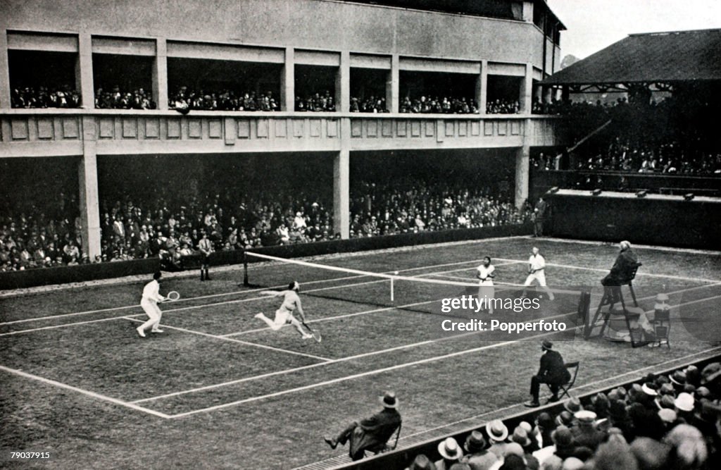 Sport. Tennis. All England Lawn Tennis Championships. Wimbledon, London, England. 1925. France's Suzanne Lenglen and Jean Borotra, left, playing Holland's H.Timmer and Mlle. Bouman on Court no1. The French pair were the 1925 Mixed Doubles Champions.