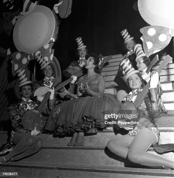 England British singer and entertainer Alma Cogan is surrounded by Tiller girls as she sings a Dixieland song on stage at the Blackpool Opera House