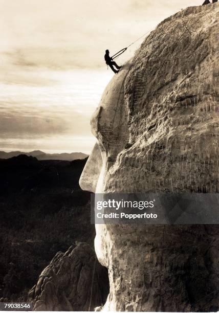 Popperfoto via Getty Images,The Book, Volume 1,Page: 93, Picture: 9, A man on the head of George Washington at Mount Rushmore, South Dakota, U,S,A,...