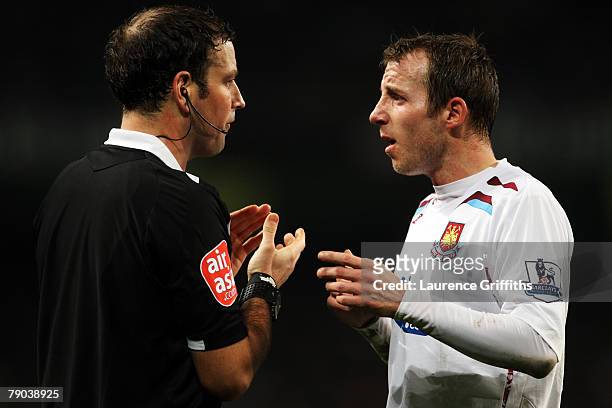 Referee Mark Clattenburg has words with Lee Bowyer of West Ham during the FA Cup sponsored by E.ON 3rd round replay match between Manchester City and...